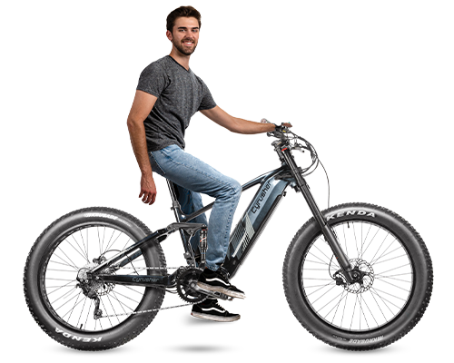 Person sitting alongside the Nitro Mountain Mid-Drive for all terrain with air shocks Ebike